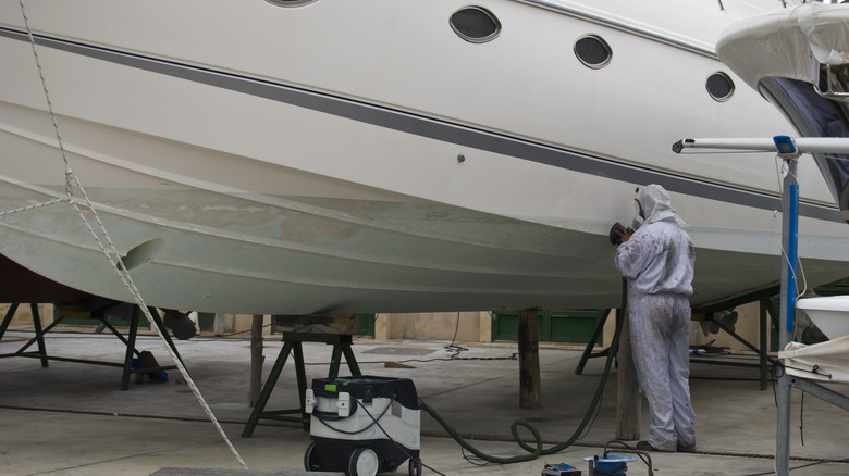Man cleaning the bottom of a boat