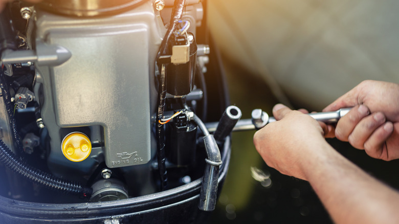 Mechanic fixing a boat motor