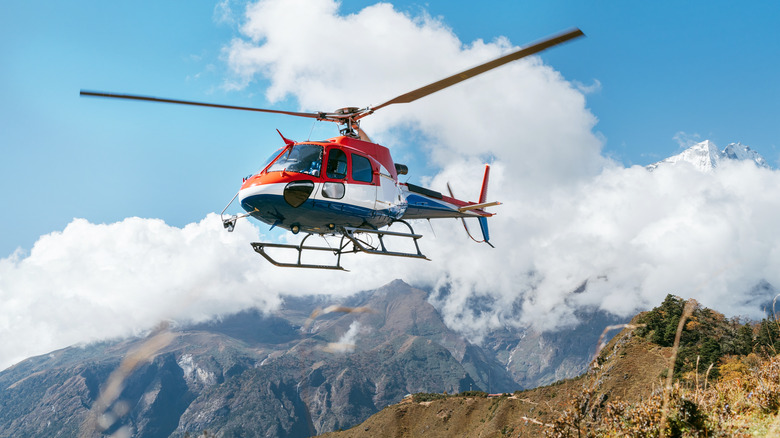 Helicopter flying over mountain