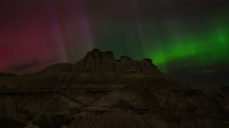 Northern lights over rock outcropping