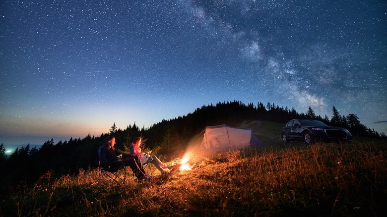Campers beneath a clear, starlit sky