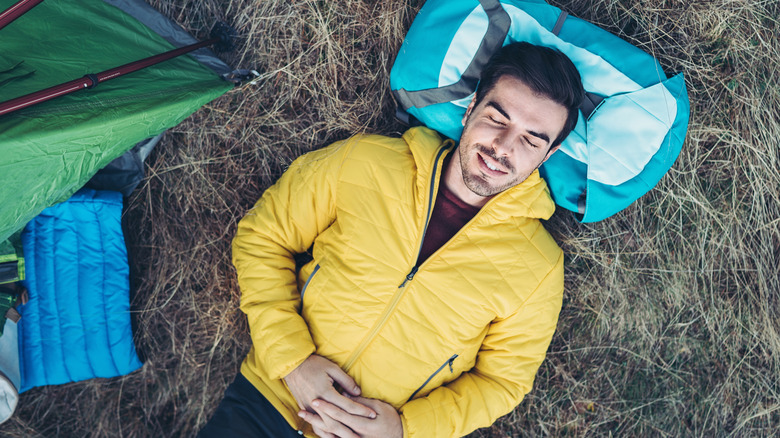 Camper resting peacefully in a light puffy jacket