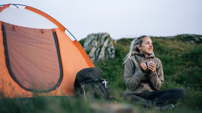 Woman camper in front of tent