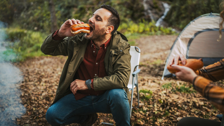 Camper eating hot dog