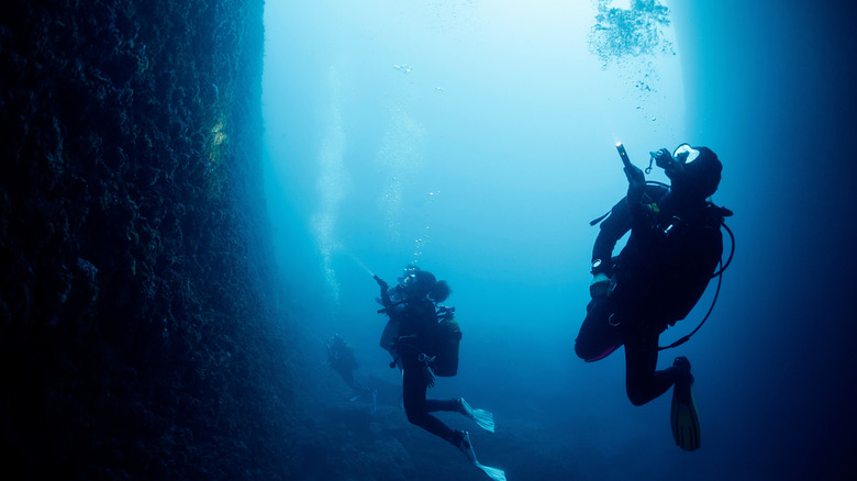 Scuba divers in an underwater cave