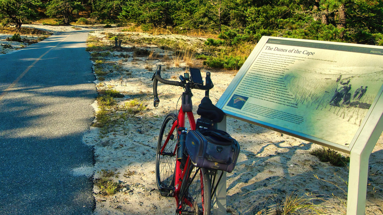 Bicycle stopped near a tourist sign on Cape Cod