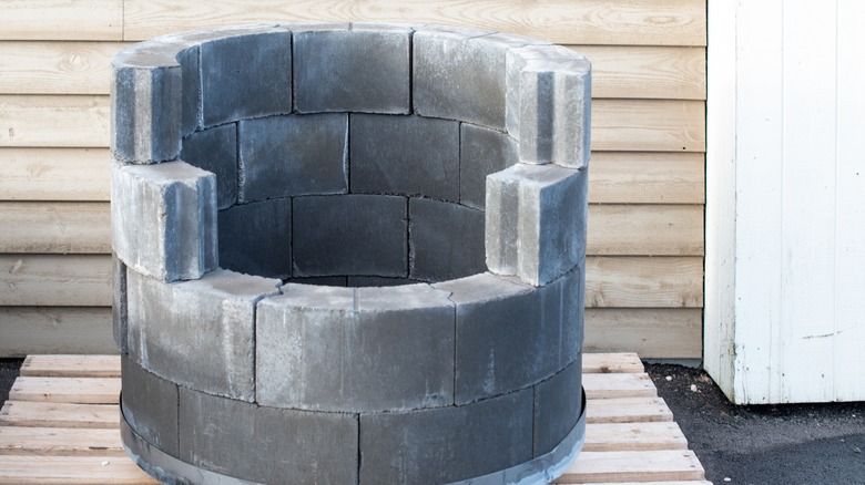 Grey pavers stacked in a circular design to make a homemade fire pit