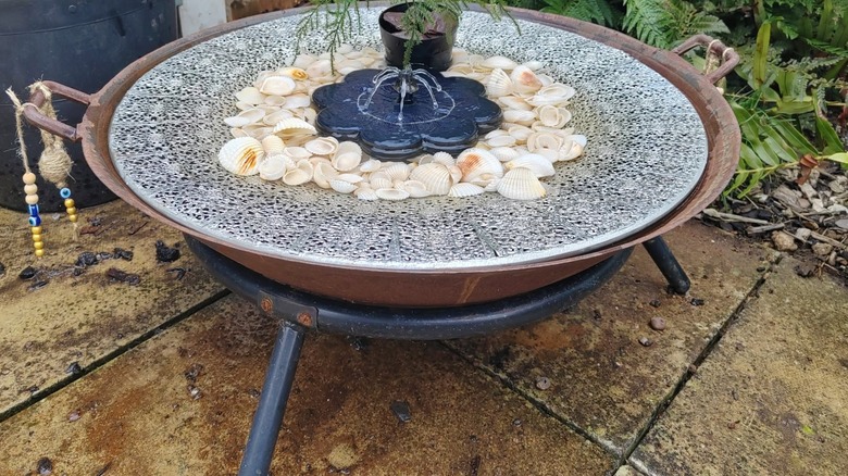 Shallow basin fire pit turned into a birdbath