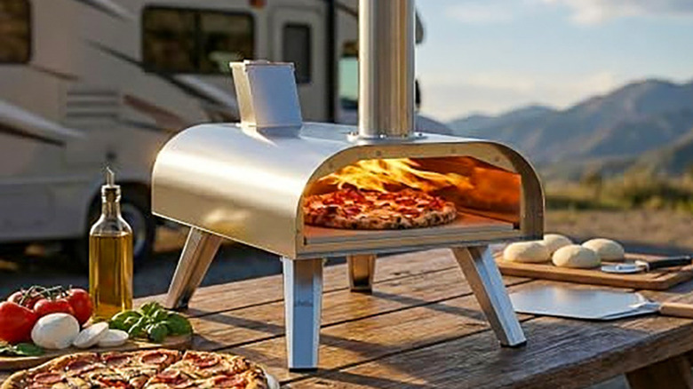 Big Horn multi-fuel outdoor pizza oven on a picnic table