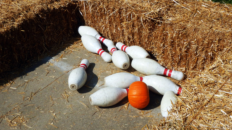 A backyard pumpkin bowling game