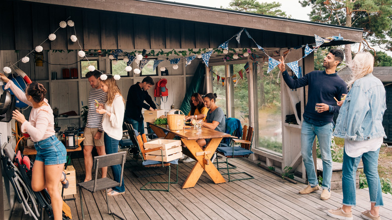A group of people on a deck having a party