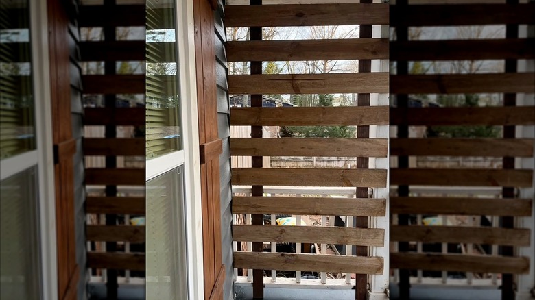 homeowner creating a DIY privacy screen for a porch
