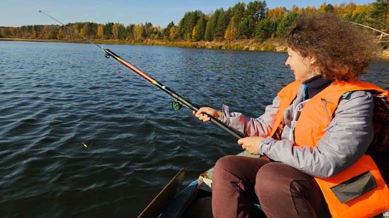 Woman fishing from a boat