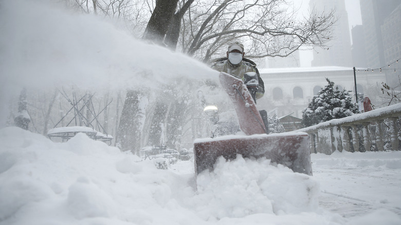 Clearing snow with snow blower