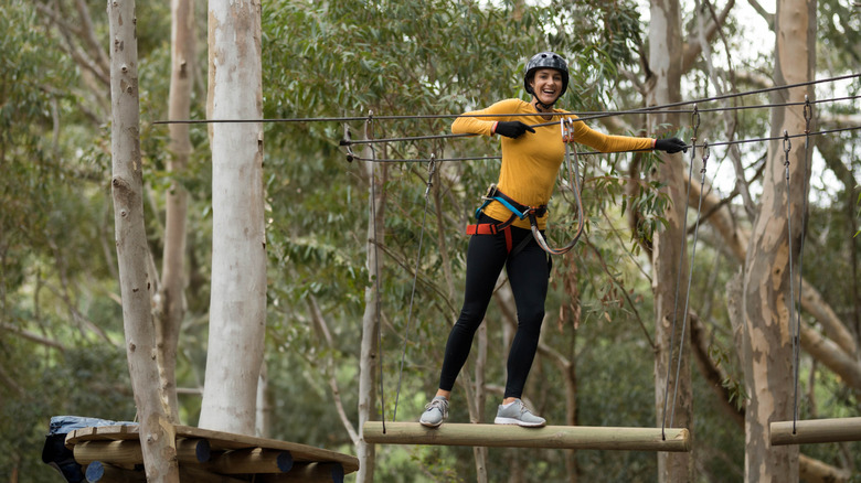 woman on accrobranche trail