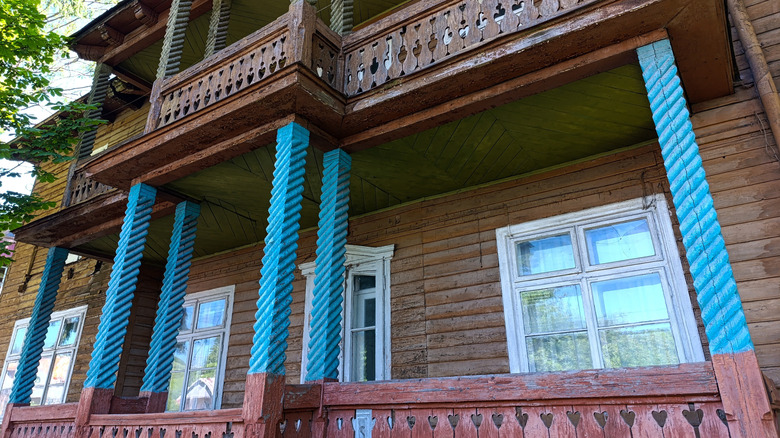 Porch on a wooden house with blue spiral porch columns