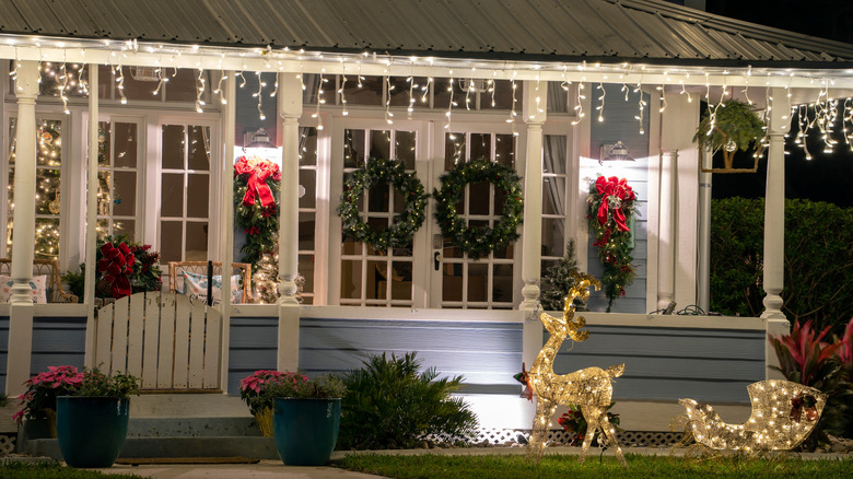Front porch decorated with Christmas wreaths and lights