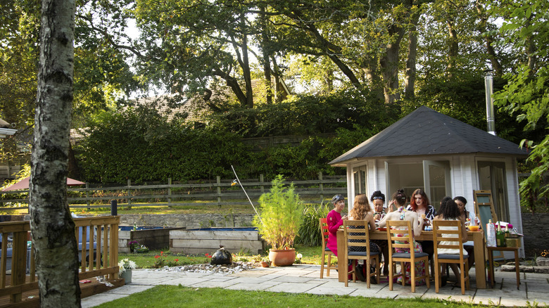 people eating together with gazebo in background