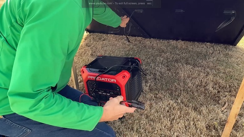 Man hooking up a Harbor Freight predator 2000 generator