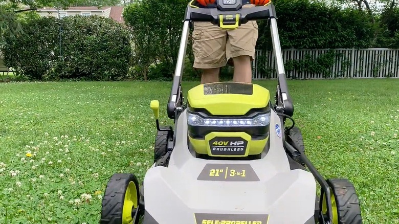 Person reviewing Ryobi 40V brushless lawn mower