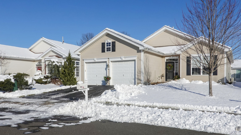 House with snowy yard and clear driveway