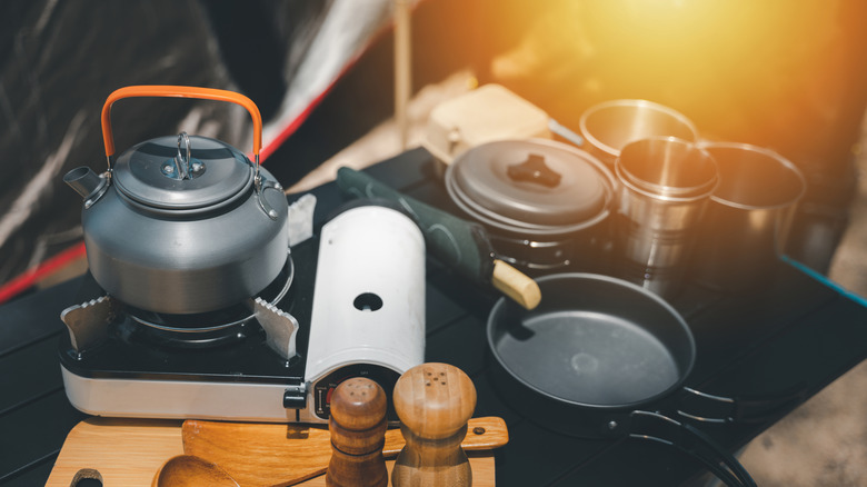 camping kitchen equipment outside a tent