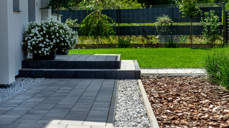 Immaculate front yard with a variety of organic and inorganic ground covers
