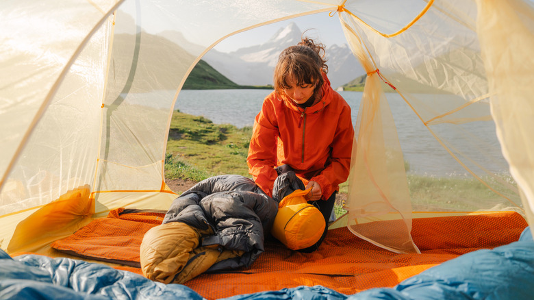 Backpacker packing their sleeping bag