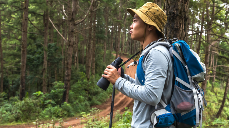Birder in the woods with backpack