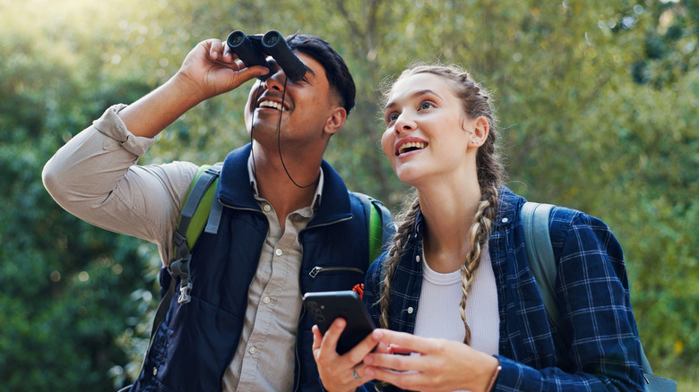 Couple birding with binoculars