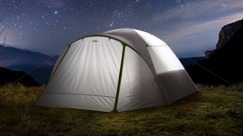 Core Equipment tent illuminated at night