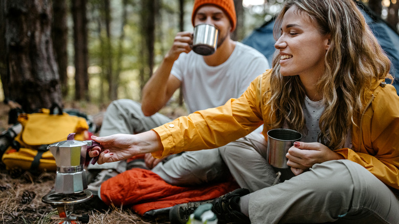 Couple camping by a fire