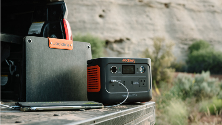 Jackery portable power station on a tailgate charging devices