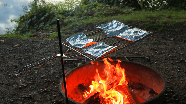 Fire with foil packet meals cooking over it