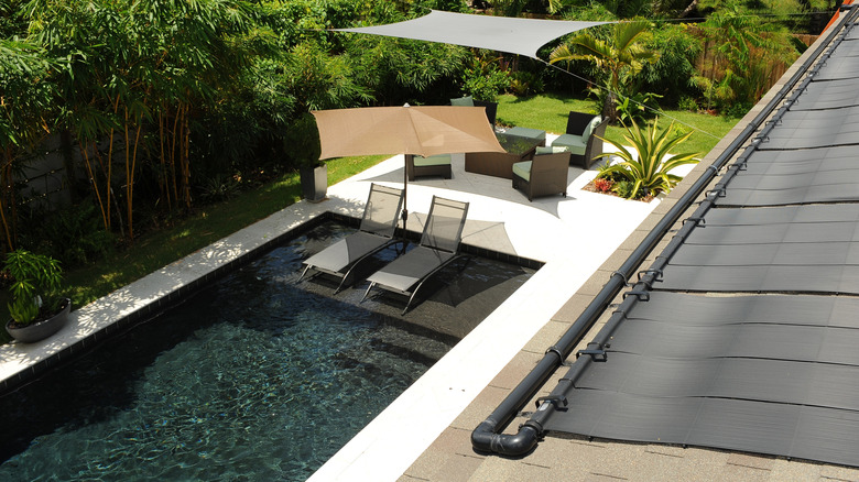 Roof mounted solar pool heater above a pool