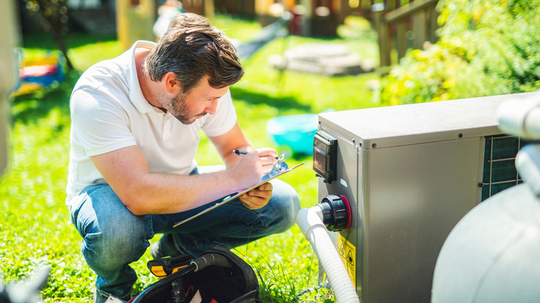 Electrician working on pool heat pump