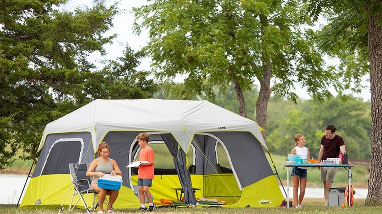 CORE 10-person instant cabin with a family of four enjoying various activities