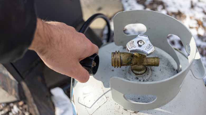 attaching smoker to propane tank on a snowy day