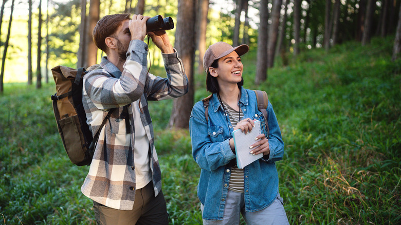hikers with binoculars bird watching while hiking