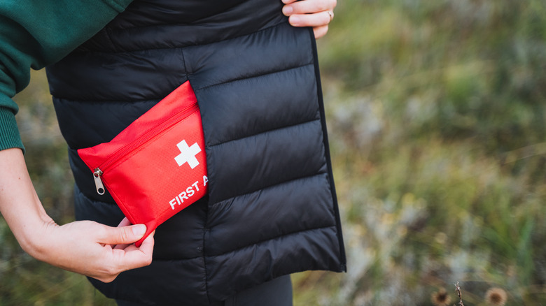 Hiker with first aid kit in pocket