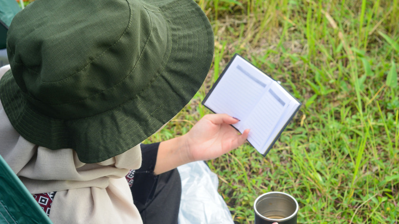 Hiker with journal and coffee