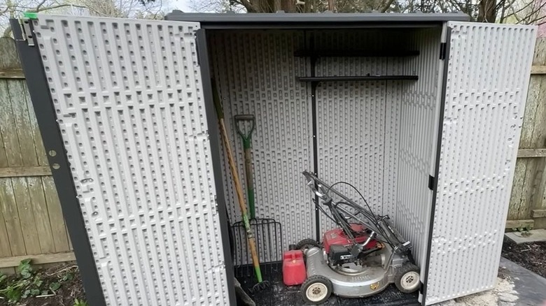 The Lifetime vertical storage shed with items inside