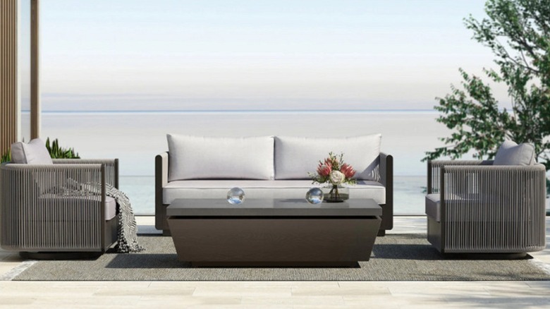 The Grand Leisure Vega 4-piece outdoor patio deep seating set with a coastal background