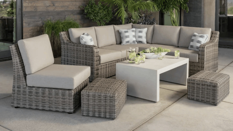 The SunVilla Kent 7-piece outdoor patio sectional set on a patio with plants in the background