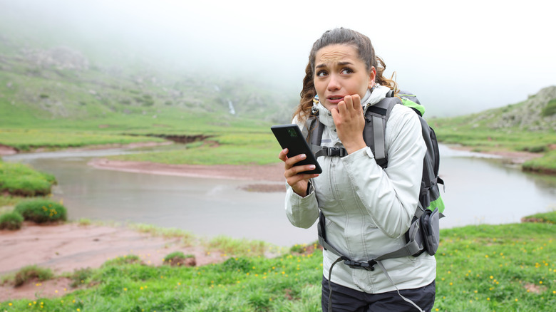 Anxious hiker beside a river