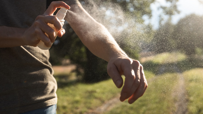 Man applying insect repellent