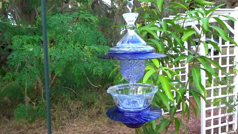 Handmade bird feeder made from vintage glassware