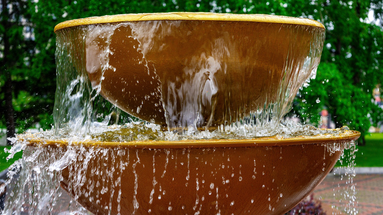 Water cascading over a two-tiered water fountain