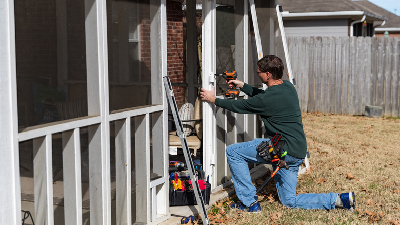 homeowner works on screened porch