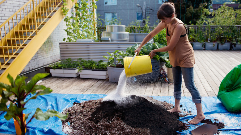 Making a DIY container garden soil mixture on a tarp